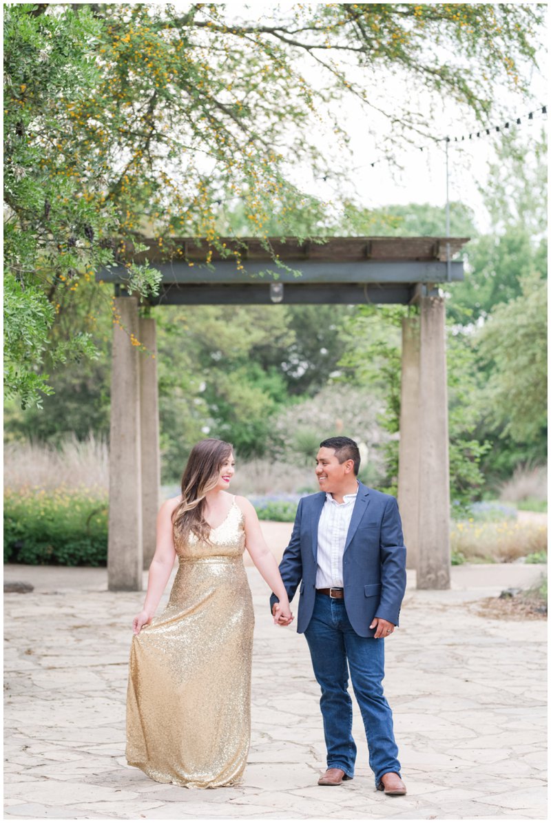 Lady Bird Johnson Wildflower Center Anniversary Photos; bride and groom hold hands walking in the garden 