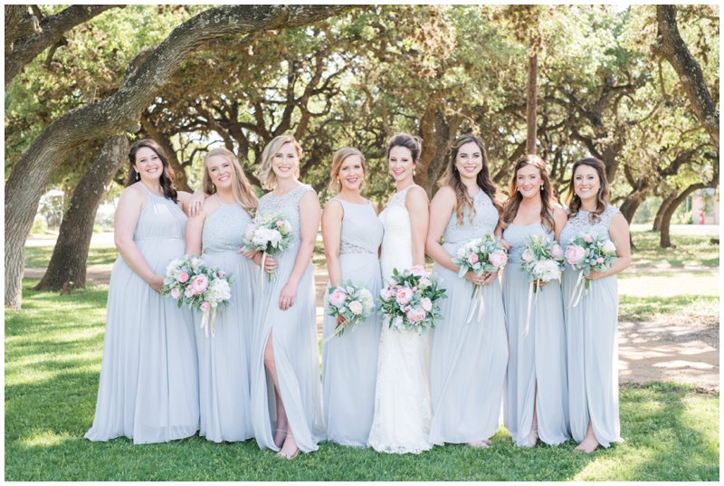 bridesmaids smile in grayed jade dresses with blush bouquets at Stonehouse Villa wedding