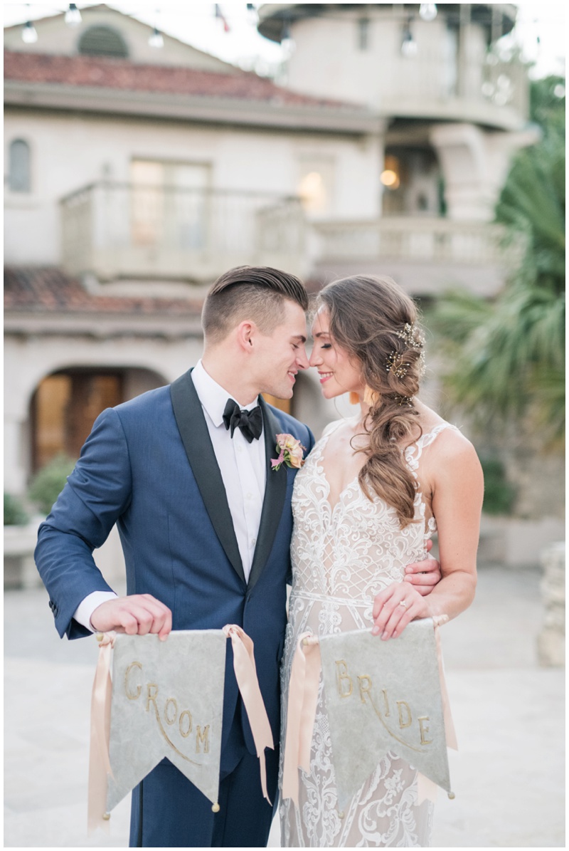 Bride and Groom hold matching signs at Villa Antonia Wedding