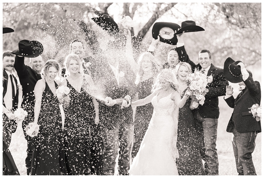 Champagne Spray with wedding party at hidden river ranch