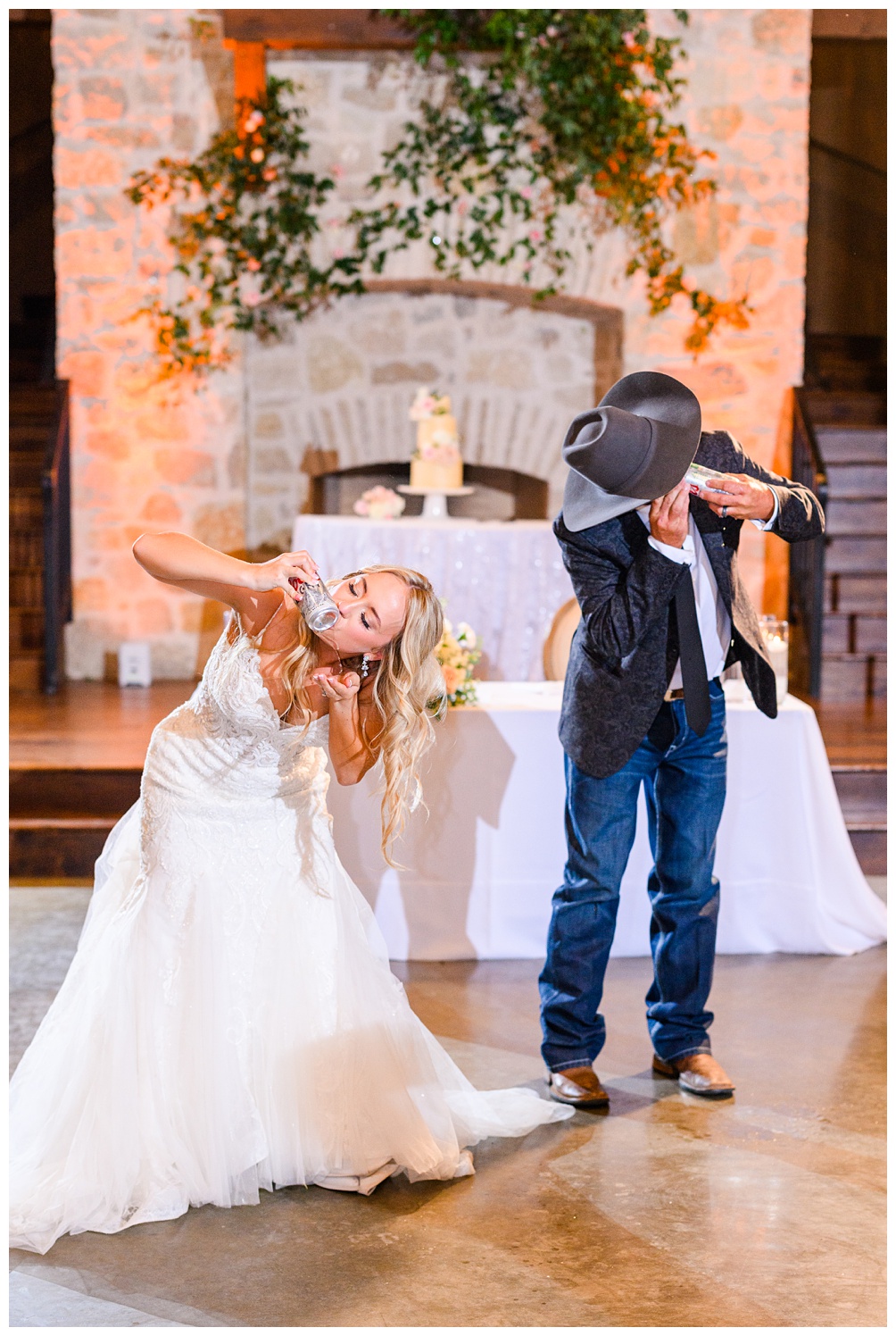 bride shotgunning a beer in wedding dress