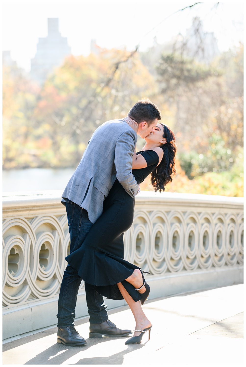 Groom dips bride on bow bridge of central park in NY