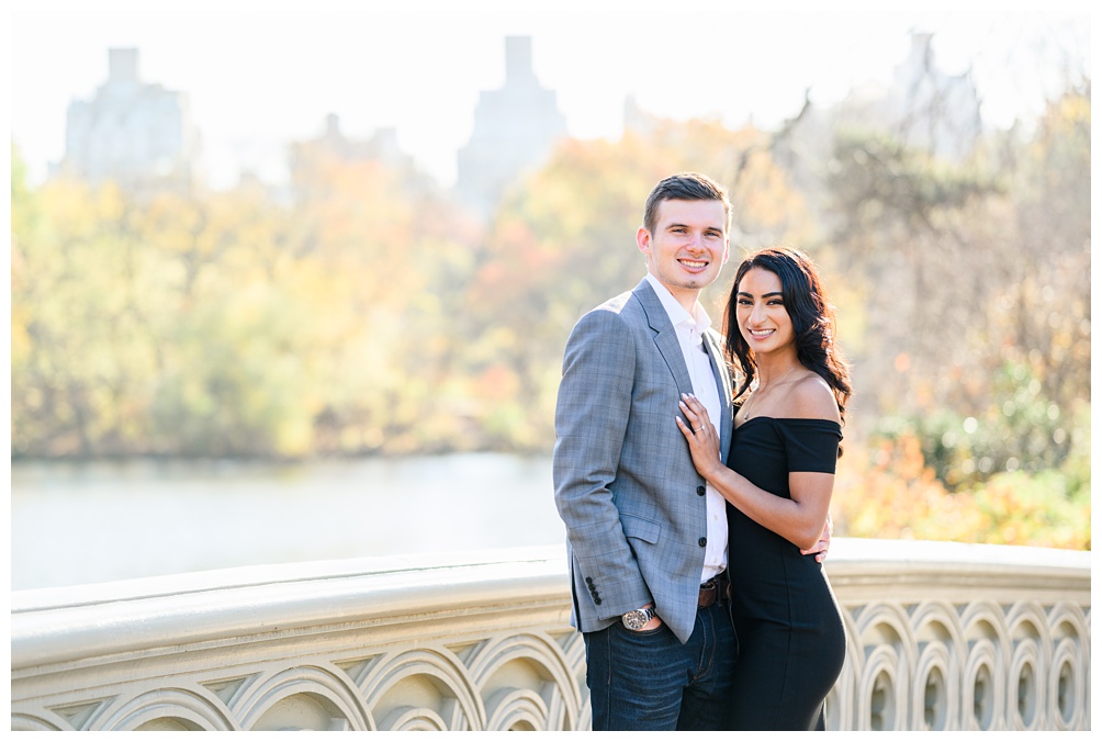 Central Park Engagement Photos on the Bow Bridge with skyline in the background