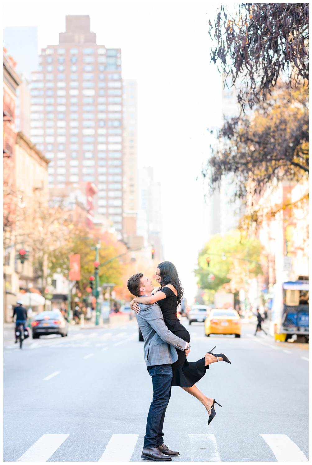 NYC engagement photos in the walkway with a taxi in the background