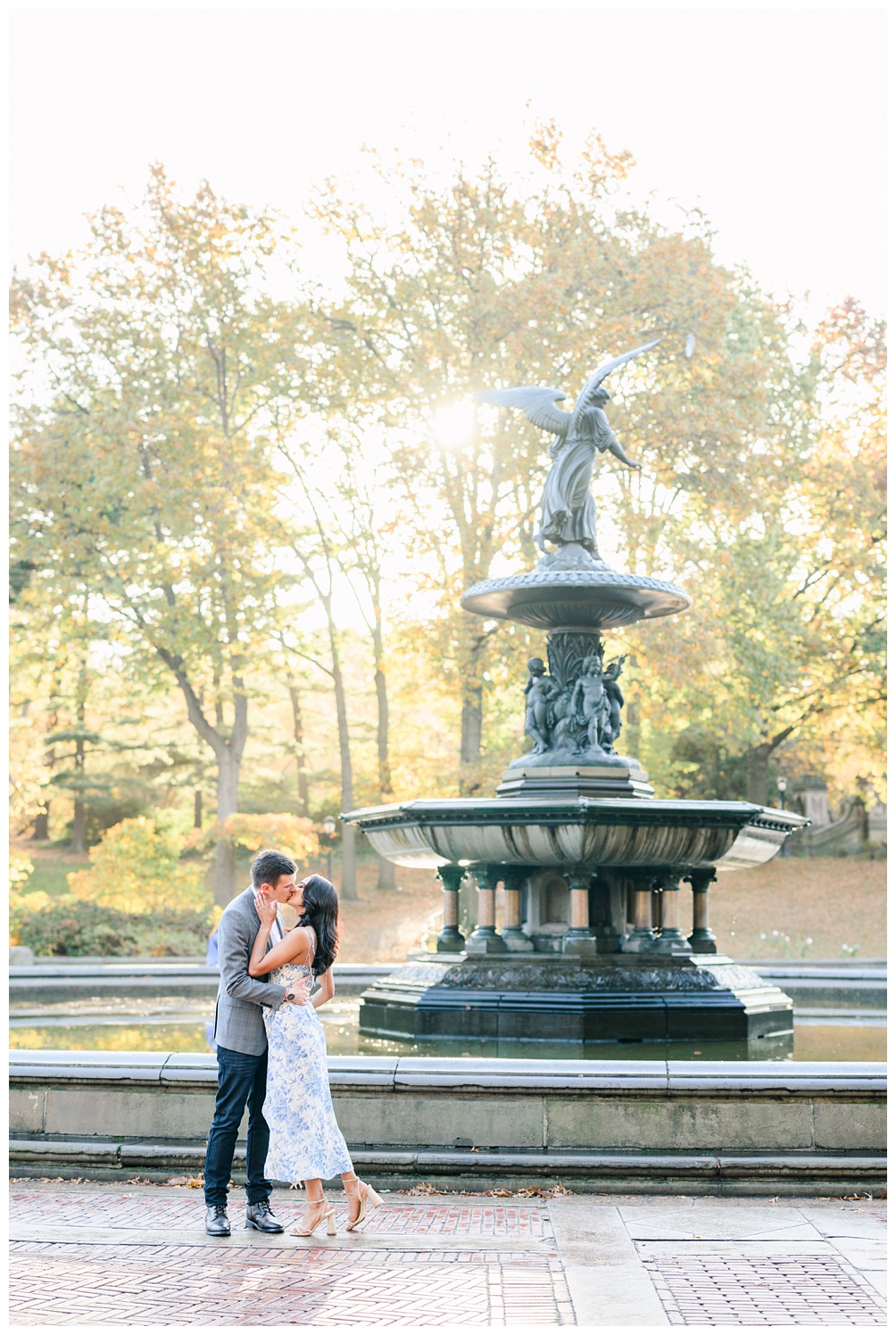 Iconic engagement photos in Central Park of New York with Bethesda Fountain in the background at sunrise 