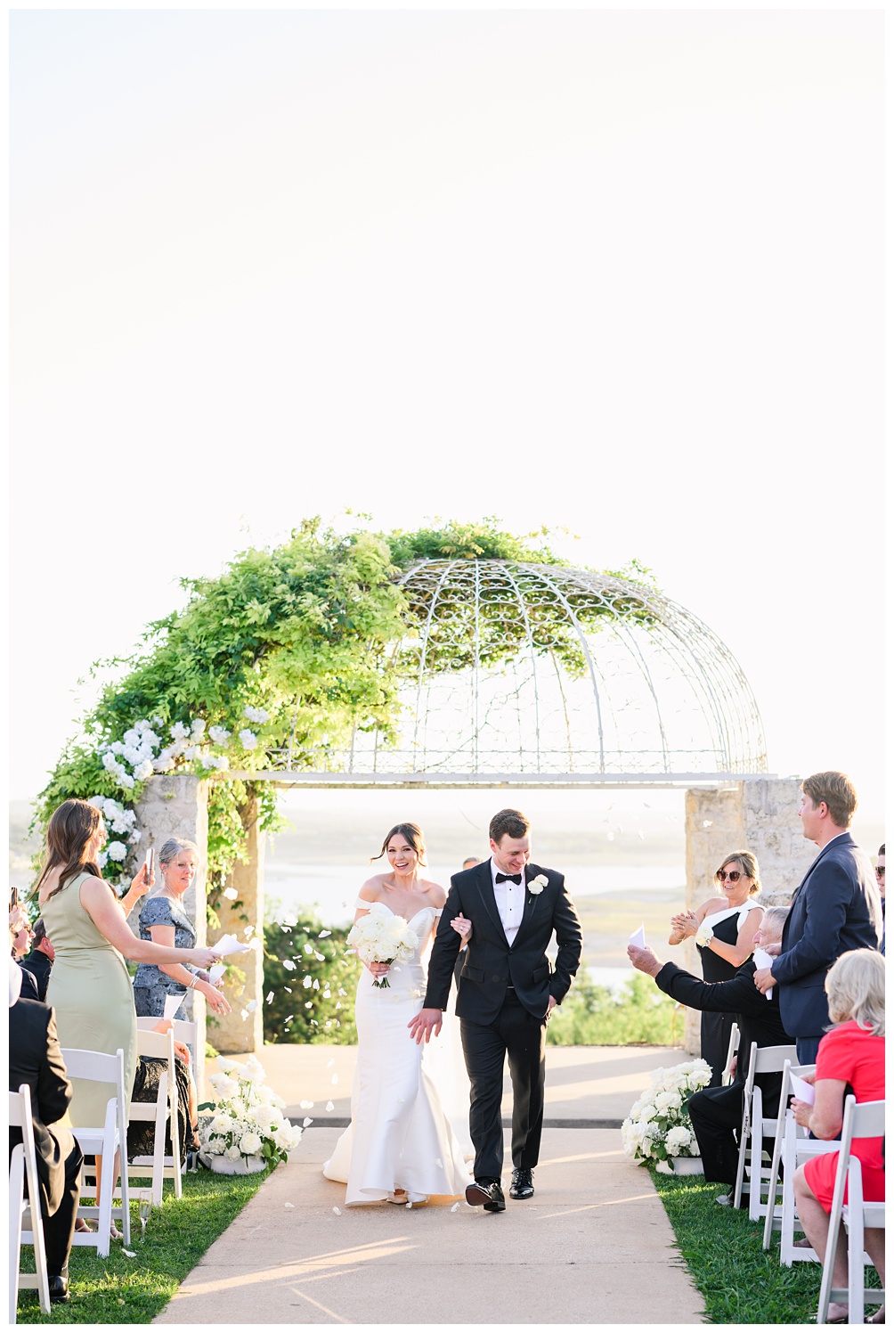 Rose petal toss at wedding ceremony at Vintage Villas overlooking lake travis in Austin Texas