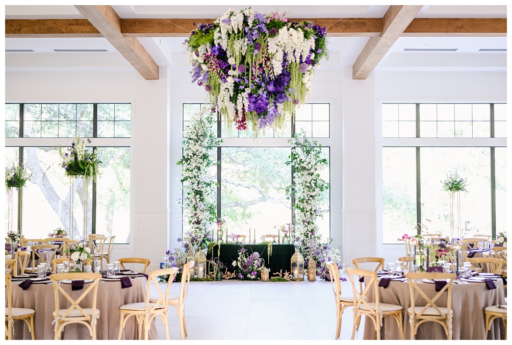 The Preserve at Canyon Lake Wedding Reception indoors with floral chandelier in purples, whites, and greens