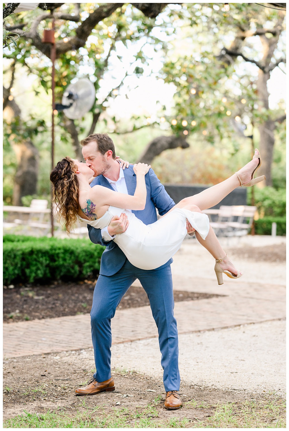 Groom sweeps bride off her feet at Mattie's in Austin, the perfect location for elopements and small weddings