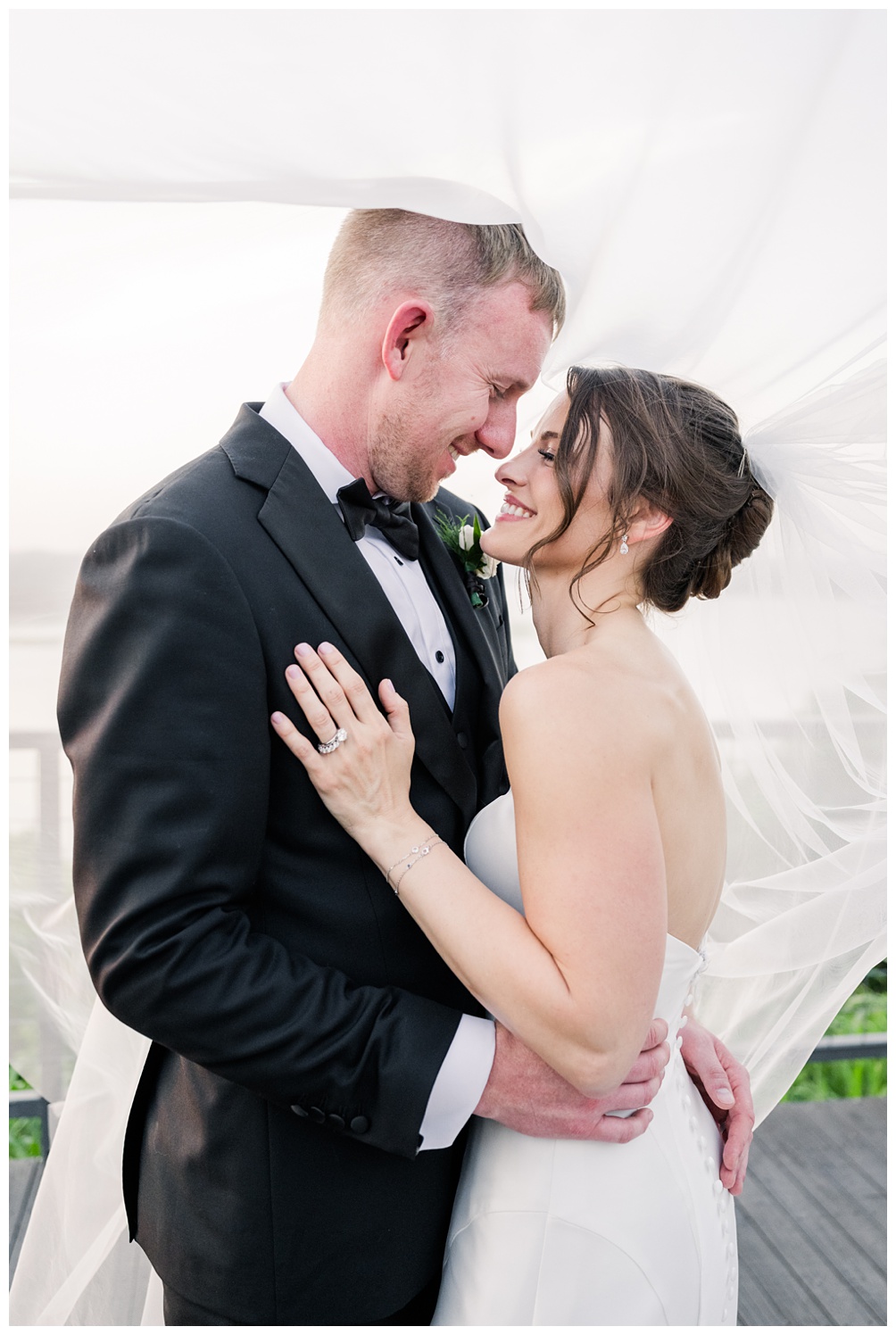 Bride and groom under veil